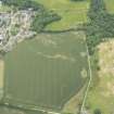 Oblique aerial view of the cropmarks of the enclosure and pits, looking NNE.