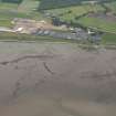 Oblique aerial view of Glenmorangie Distillery with the fish trap in the foreground, looking NNW.