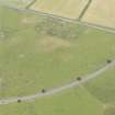 Oblique aerial view of the parchmarks of the enclosure and pits, looking NW.