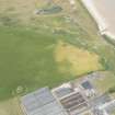 Oblique aerial view of the remains of the windmill at Sandend, looking NW.