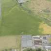 Oblique aerial view of the cropmarks of the ring ditch and the remains of the windmill at Sandend, looking WNW.