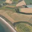 Oblique aerial view of the area of unenclosed settlement at Newbarns, Lunan Bay, looking SW.