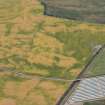 Oblique aerial view of the cropmarks of the palisaded settlements, round houses and pits at Ironshill, Inverkeilor,  looking SE.