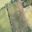 Oblique aerial view of the cropmarks of the unenclosed settlement, pits and rig, looking E.