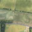 Oblique aerial view of the cropmarks of the unenclosed settlement, pits and rig, looking NW.