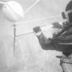 Operating the free-standing camera-tower designed to prepare photo-mosaics on the Duart Point wreck. The rig is levelled by means of a two-way spirit level. Note the triangular yellow targets used to set out a reference grid of 1m squares. (Colin Martin)