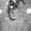 Operating the free-standing camera-tower designed to prepare photo-mosaics on the Duart Point wreck. The rig is levelled by means of a two-way spirit level. Note the triangular yellow targets used to set out a reference grid of 1m squares. (Colin Martin)