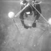 Operating the free-standing camera-tower designed to prepare photo-mosaics on the Duart Point wreck. The rig is levelled by means of a two-way spirit level. Note the triangular yellow targets used to set out a reference grid of 1m squares. (Colin Martin)