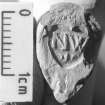 ‘NW’ heel mark (Type A2) on a clay pipe (DP00/147), denoting an unidentified Newcastle maker. Scale 1 centimetre. (Colin Martin)