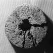 The upper stone of a hand-mill or quern (DP02/003a), showing its grinding face. Diameter 316mm. (Colin Martin)