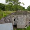 Kiln B from the top of Kiln A. The levelled causeway from the quarry is seen running to the top of Kiln B from centre left. The SE draw-arch is at the lower right, while the doorway into the room behind the kilns is towards the left, beneath two ventilation slots. Support slots and masonry fill above them indicate the probable abutment of a demolished bridge, once linking Kilns A and B. The upper levels of Kiln B suggest a later heightening of the structure. Scale 2 metres. (Colin Martin)