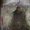 The inner arch of the right-hand pot of Kiln B. The end wall has been breached to reveal the brickwork of the pot. The outer wall of the kiln and the draw-hole are harled. Scale 2 metres. (Colin Martin)
