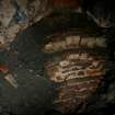 Brick-built interior of the lower part of the right-hand pot of Kiln B, showing its tiered construction. The infill between the outer wall of the kiln and the pot appears to be a mixture of earth, brick and gravel ballast, and ash. (Colin Martin)