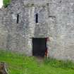 Rear section of the SE side of the Kiln B, showing the door (minus its lintel) to a large room behind the kiln, two ventilation slots, and features associated with the probable demolished bridge which once linked Kilns A and B. Scale 2 metres. (Colin Martin)