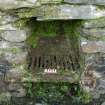 Iron grate in situ in the stoke-hole of the pot of Kiln 3 at Sailean B. Scale 10 centimetres. (Colin Martin)