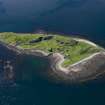 Aerial photograph of Sheep Island from the SE. The three kilns and associated buildings are clustered round the small bay. On the left is a horseshoe-shaped reef (an Càrn = pile of stones) which appears to have served as a ballast dump. (Colin Martin)