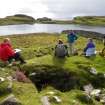 This site has elicited much interest and discussion from heritage agencies and others. Here, seated on the remains of a Neolithic chambered cairn overlooking Loch na h-Airde in September 2013, an informal international seminar is taking place. From left, Philip Robertson (Historic Scotland), George Geddes (Royal Commission on the Ancient and Historic Monuments of Scotland), Edward Martin (archaeological photographer), and Dr Ian MacLeod (Western Australian Museum). Behind the camera is Dr Colin Martin (University of St Andrews). (Colin Martin)