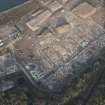 Oblique aerial view of the remains of Inverkip power station during post-demolition clearance, looking to the NNW.