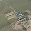 Oblique aerial view of Castlandhill Radio Station, pillboxes, farmsteading, cottage and reservoirs, looking NNE.