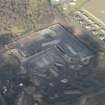 Oblique aerial view of partially demolished fuel oil store tank, looking NNW.
