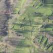 Oblique aerial view centred on part of the disused race course, the farmstead and the golf course, looking W.
