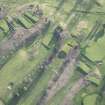 Oblique aerial view centred on part of the disused race course, the farmstead and the golf course, looking SSW.