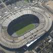 Oblique aerial view of Hampden Park being converted to a Commonwealth games venue, looking to the SSE.