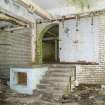 Interior. Ground Floor. Dispatch and Office Area looking towards dairy area from north west.  View of arched doorway, loading platform and stair.