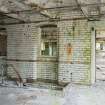 Interior. First floor. View of former external east wall of 1911 range with tower from west. Post 1911 extension beyond. Stairs accessing lower floor visible