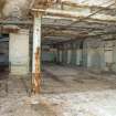 Interior. 1911 range range where it meets 1911 former one storey west range (note ceiling concrete arch configuration)from south which butts against the 1890s creamery building thick masonry former external south wall on left, to the south and to the east. The column provides support to allow this open work area, dispensing with the need for a  cross wall.