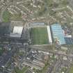 Oblique aerial view of Palmerston Park, home of Queen of the South FC, looking NNE.