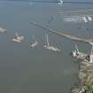 Oblique aerial view of the construction of the Queensferry Crossing on the south bank of the River Forth, looking E.