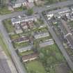 Oblique aerial view of five long rectangular single story timber  houses, looking NNE.