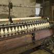 Interior. Main mill building, detail of spinning mules (Platt Brothers, Oldham, c.1870)