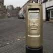 Detail of Royal Mail post box painted gold to commemorate Andy Murray's Gold Olympic Medal in 2012.