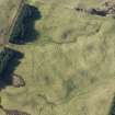 Oblique aerial view of a hut circle, field system and rig and furrow at Achvraid, looking W.