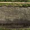 View of cross slab with two incised crosses and incised axe (including scale)