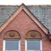 Detail of carved panels above left south facing first floor windows.