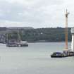 Forth crossing under construction. General view of south end of bridge and support pillars from road bridge to north east