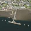 Oblique aerial view of Invergordon centred ont he pier, looking NW.