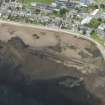 Oblique aerial view of Golspie centred on the breakwaters, looking NW.