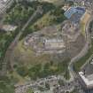 Oblique aerial view of Edinburgh Castle and Esplanade, looking NE.