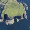 Oblique aerial view of Staffa centred on Fingal's Cave, looking NE.