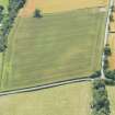 Oblique aerial view of the cropmarks of the enclosure, looking WSW.