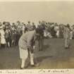 View of golfers and spectators possibly at the Old Course in St Andrews.