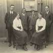 Uncaptioned photograph of a group of six people standing outside of a drawing office.