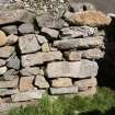 Blackhouse V, blocked window opening and areas of rebuilding in the ENE wall.