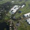 Oblique aerial view of The PGA Golf Course Spectator Village and 1st Tee, looking E.