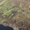 Oblique aerial view of the concrete hut bases for the possible officer's buildings and part of the military camp, looking SW.