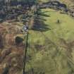 Oblique aerial view of the southern terminal of the Loch Doon Gunnery School railway,  cutting across the field and ending at a small loading platform by the Gaw Glen Burn, looking WSW.